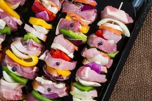 Raw pork skewers ready for grilling photo