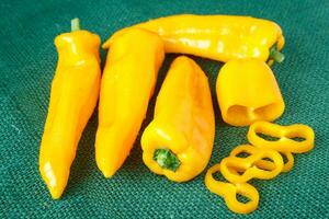 Yellow sweet pepper on green background photo