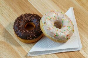 Delicious donuts with white and chocolate icing photo