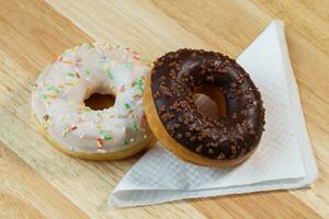 Delicious donuts with white and chocolate icing photo