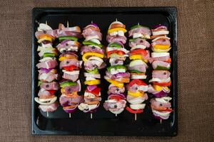 Raw pork skewers ready for grilling photo