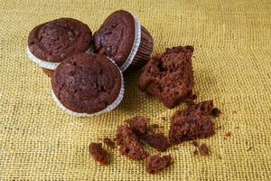 Chocolate chip muffin on a rustic background photo