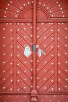 Beautiful old red wooden door in castle photo