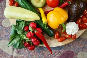 Pile of fresh vegetables on colored fabric photo