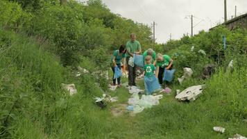 Volunteer team cleaning up dirty park from plastic bags, bottles. Reduce trash cellophane pollution video