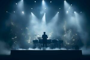 Silhouette of a man performing on stage in front of a stage lights photo