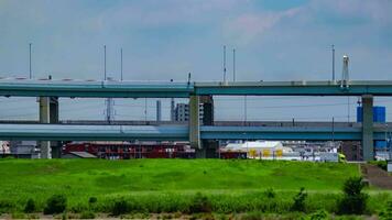 A timelapse of traffic jam at the downtown street and highway telephoto shot tilt video