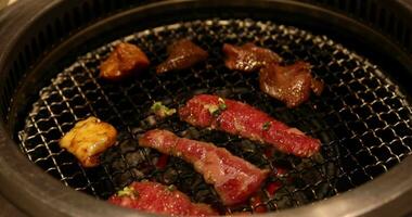 Japanese style bbq Yakiniku with Wagyu beef sliced close up handheld shot video