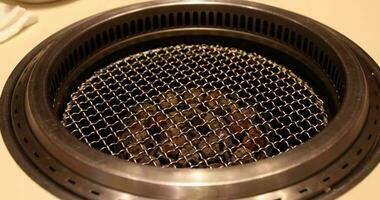 A plate of Japanese style bbq Yakiniku with Wagyu beef sliced close up handheld shot video