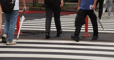 A walking people's leg at the city street in Nishishinjuku Tokyo telephoto shot video