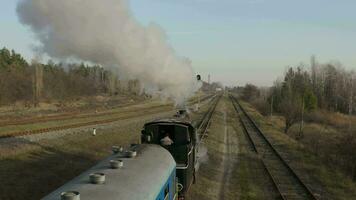 Aerial view of old steam locomotive on the tracks in the countryside. Narrow gauge railway. Autumn. video