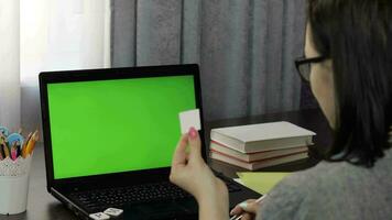 Woman teacher making online distance education video call on laptop green screen