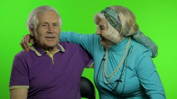 Mature senior old couple family grandparents enjoy talking, hugging. Chroma key video