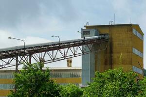 Big silos, belt conveyors and mining equipment in a quarry. Mining industry in quarry. photo