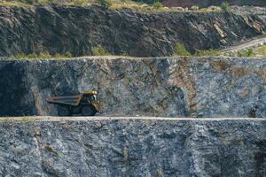 Dump truck in limestone mining, heavy machinery. Mining in the quarry. photo