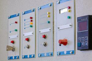 Switches on an industrial control board. Lamp indicator and switch of power control panel. photo