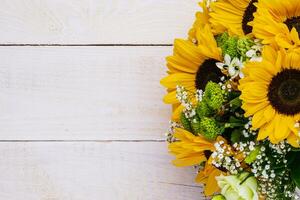 Wedding bouquet of sunflower on a wooden background. Top view with copy space. photo