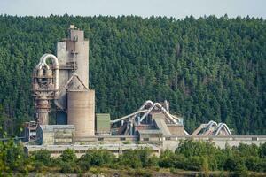 Opencast mining quarry with machinery and mining equipment. Limestone mining for cement production. photo