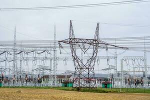 Distribution electric substation with power lines and transformers. High voltage power transformer substation. photo