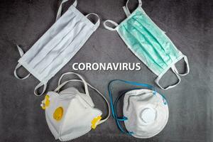 Text phrase Coronavirus on black background with protective medical masks and respirator masks FFP2. Mask protection against pollution, virus, flu and coronavirus 2019-nCoV. photo