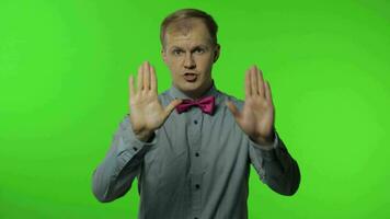 Guy showing stop gesture with hands. No, never, disliking and rejecting sign. People emotions video