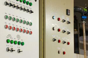 Switches on an industrial control board. Lamp indicator and switch of power control panel. photo