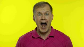 Portrait of young caucasian man posing in pink t-shirt. Amazed handsome guy shocked, surprised video