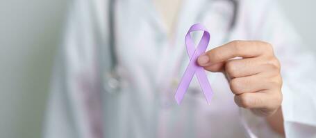 Doctor with purple ribbon for world cancer day, lupus, Pancreatic, Esophageal, Testicular cancer, world Alzheimer, epilepsy, Sarcoidosis, Fibromyalgia and domestic violence Awareness month concepts photo