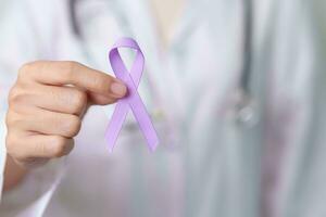 Doctor with purple ribbon for world cancer day, lupus, Pancreatic, Esophageal, Testicular cancer, world Alzheimer, epilepsy, Sarcoidosis, Fibromyalgia and domestic violence Awareness month concepts photo