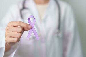 Doctor with purple ribbon for world cancer day, lupus, Pancreatic, Esophageal, Testicular cancer, world Alzheimer, epilepsy, Sarcoidosis, Fibromyalgia and domestic violence Awareness month concepts photo