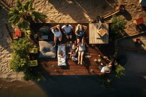 AI generated Top view of a group of friends having a barbecue on the beach, AI Generated photo