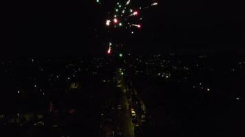 Aerial View of Illuminated City During Dark Night and Live Fireworks on New Year's Night over Luton, England UK. January 1st, 2024 video