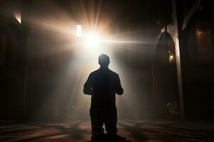 AI generated silhouette muslim man praying n the mosque photo