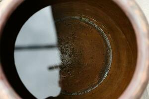 water in a clay pot, close-up view. photo