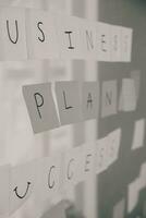 Young creative team professional using post it notes in glass wall to writing strategy business plan to development grow to success. photo