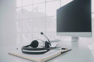 Communication support, call center and customer service help desk. VOIP headset on telephone keyboard. photo