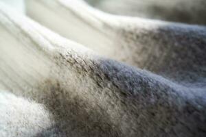 The texture of a warm sweater with a beige pattern. photo
