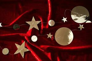 Abstract Christmas background made of red velvet fabric with stars. photo