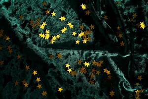 Abstract Christmas background with gold stars on a green velvet background. photo