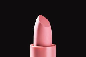 Pink lipstick on a dark background. photo