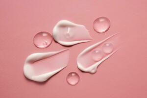 Gel, serum and a cream on a pink background. photo