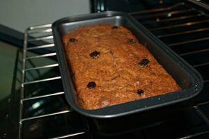 Banana bread with raisins in oven 5 photo