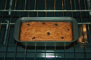 Banana bread with raisins in oven 1 photo