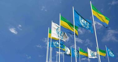 Gabon et uni nations, ONU drapeaux agitant ensemble dans le ciel, sans couture boucle dans vent, espace sur la gauche côté pour conception ou information, 3d le rendu video