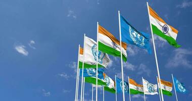 India and United Nations, UN Flags Waving Together in the Sky, Seamless Loop in Wind, Space on Left Side for Design or Information, 3D Rendering video