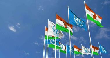 Niger and United Nations, UN Flags Waving Together in the Sky, Seamless Loop in Wind, Space on Left Side for Design or Information, 3D Rendering video