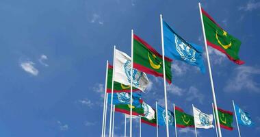 Mauritania and United Nations, UN Flags Waving Together in the Sky, Seamless Loop in Wind, Space on Left Side for Design or Information, 3D Rendering video