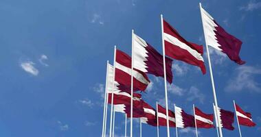 Latvia and Qatar Flags Waving Together in the Sky, Seamless Loop in Wind, Space on Left Side for Design or Information, 3D Rendering video