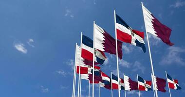 Dominican Republic and Qatar Flags Waving Together in the Sky, Seamless Loop in Wind, Space on Left Side for Design or Information, 3D Rendering video