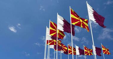 Norden Mazedonien und Katar Flaggen winken zusammen im das Himmel, nahtlos Schleife im Wind, Raum auf links Seite zum Design oder Information, 3d Rendern video